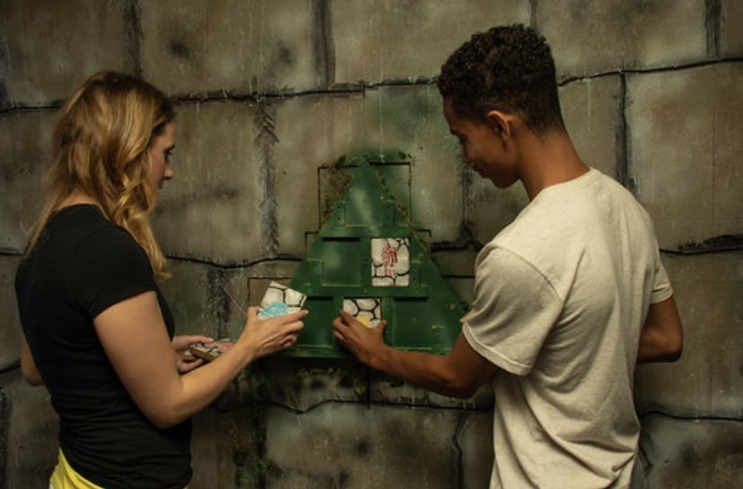 two people working on an escape room puzzle